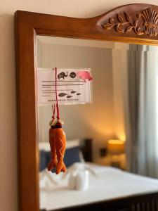 a reflection of a carrot on a string in a mirror at See You Soon, Chiang Mai in Chiang Mai