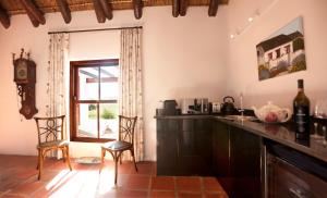 
a kitchen filled with furniture and a window at Aaldering Luxury Lodges in Stellenbosch
