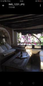 a living room with a bottle of wine on a table at Wildebeeste Lamu in Lamu