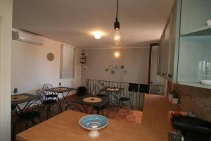 a restaurant with tables and chairs in a room at Casa Levante in Oliveri