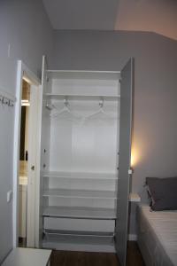 a room with a bed and a closet with hangers at Vielha Centro Estudio in Vielha +29 photos