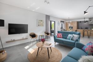 a living room with a blue couch and a table at VILLA DEL SOL in Labin