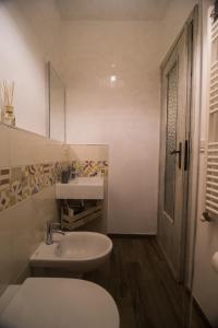 a white bathroom with a sink and a toilet at A cà da Susi in La Spezia +56 photos