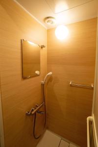 a bathroom with a shower with a mirror at Ebisuya / Vacation STAY 5850 in Kofu