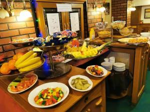 a buffet with many plates of food on a table at River Star Hotel in Prague