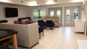 a waiting room with a table and chairs at Holiday Inn Express & Suites Colorado Springs North, an IHG Hotel in Colorado Springs