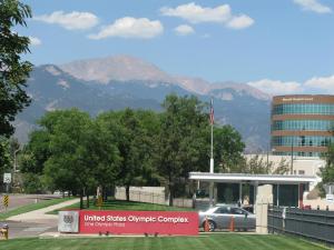 a car parked in front of a building with mountains in the background at Holiday Inn Express & Suites Colorado Springs North, an IHG Hotel in Colorado Springs