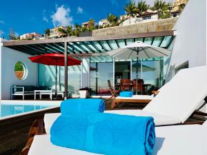 a villa with a swimming pool and a patio at Villa Mar Garajau in Caniço