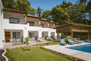 a villa with a swimming pool and a resort at Solez Zihuatanejo in Zihuatanejo