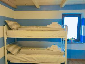 a bedroom with two bunk beds in a room at Alice’s House in Fonteno