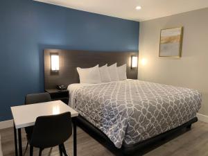 una camera d'albergo con letto, tavolo e sedie di Motel Sakura a Glendale