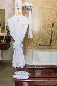 a white towel hanging on a towel rack in a bathroom at Mansión Mérida Boutique Hotel - Restaurant in Mérida