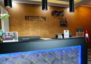a reception desk with a sign that reads reception at Boardinghouse City Home in Bielefeld