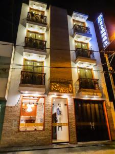 a facade of a hotel at night at Retama Hotel in Tacna