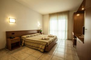 a hotel room with a bed and a window at Hotel Davide in Rivoli