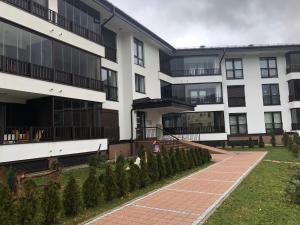 an apartment building with a pathway in front of it at Apartment Bjelasnica in Bjelašnica