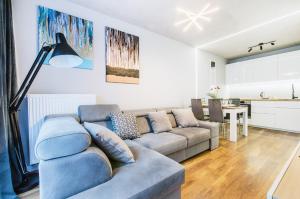 a living room with a couch and a table at Smart Rental Management Apartments in Wrocław