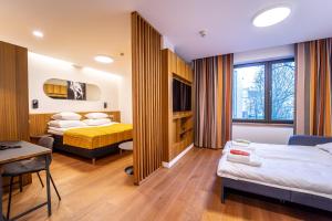 Postel nebo postele na pokoji v ubytování Hestia Hotel Kentmanni + 37 fotografií