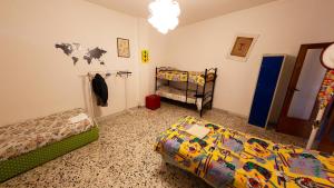 a bedroom with two beds and a crib at The Homestay - Arezzo in Arezzo
