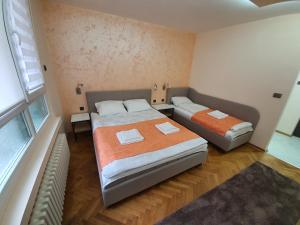 Кровать или кровати в номере Apartman DoDoLu