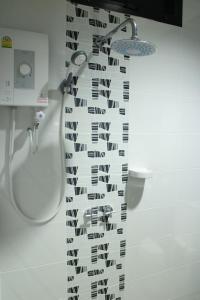 a shower curtain with black and white music notes at The Siri Place in Udon Thani