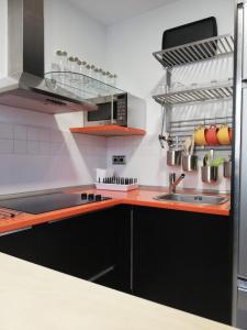 a kitchen with a sink and a counter top at The Little House Sir in Ávila