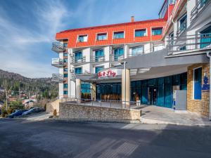 a building with a sign on the front of it at Hotel Ski&Sky in Predeal