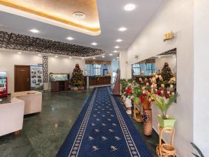 a lobby with christmas trees and christmas decorations at Hotel Ski&Sky in Predeal