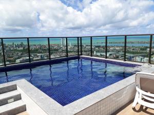 a swimming pool on the roof of a building at Beach Class Ilha do Leite in Recife