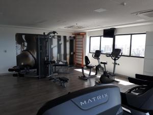 a gym with treadmills and machines in a room at Beach Class Ilha do Leite in Recife