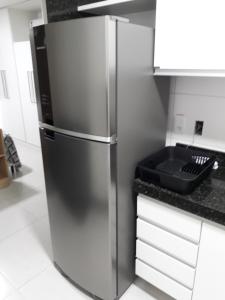 a stainless steel refrigerator in a kitchen at Beach Class Ilha do Leite in Recife