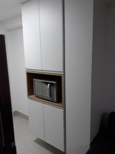 a microwave in a cabinet in a room at Beach Class Ilha do Leite in Recife +48 photos