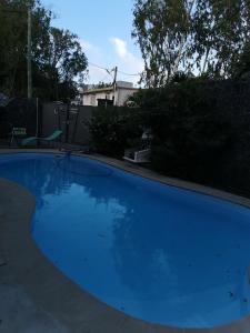 a large blue swimming pool in a yard at JKB Villa in Pamplemousses Village