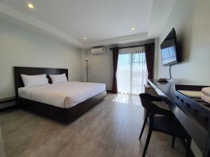 Postel nebo postele na pokoji v ubytování T-NEE Hotel@Udon