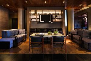 
a living room filled with furniture and a table at Ink 48 Hotel in New York
