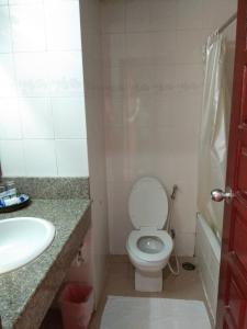 a bathroom with a toilet and a sink and a tub at Inn Come Hotel Chiang Rai in Chiang Rai