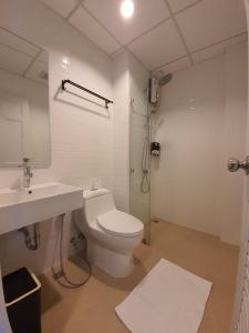 a bathroom with a toilet and a sink and a shower at T-NEE Hotel@Udon in Udon Thani