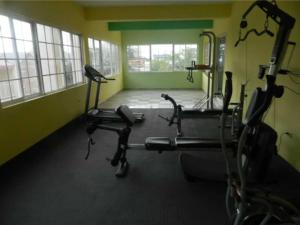 a gym with three exercise bikes in a room at The Artist Place Kensington 1BR New Kingston in Kingston