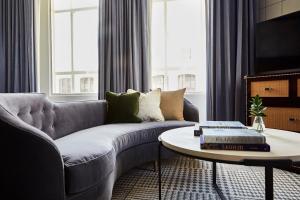 a living room with a couch and a coffee table at Kimpton Hotel Monaco Denver by IHG in Denver +106 photos
