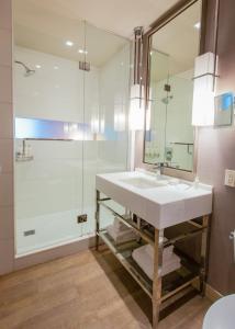 a bathroom with a sink and a shower at Kimpton Hotel Wilshire, an IHG Hotel in Los Angeles
