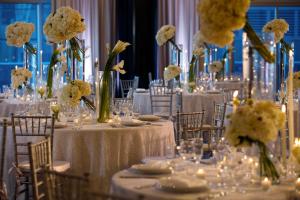 a group of tables with white flowers on them at Kimpton EPIC Hotel, an IHG Hotel in Miami