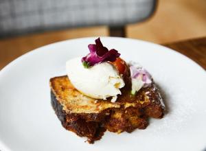 a white plate topped with a piece of cake at Kimpton Riverplace Hotel, an IHG Hotel in Portland