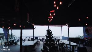 a restaurant with tables and chairs and lights at เฟรนด์แคมป์ in Khao Kho