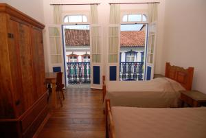 A bed or beds in a room at Alquimia House