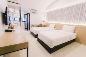 Postel nebo postele na pokoji v ubytování Royal Princess City Lamphun Hotel