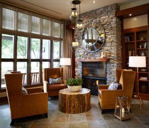 a living room filled with furniture and a fireplace at Kimpton Riverplace Hotel, an IHG Hotel in Portland