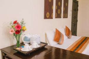 Postel nebo postele na pokoji v ubytování Royal Princess City Lamphun Hotel