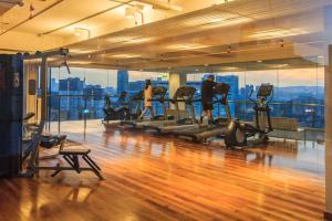 a gym with people exercising on tread machines in a building at D'majestic Place by Homes Asian in Kuala Lumpur