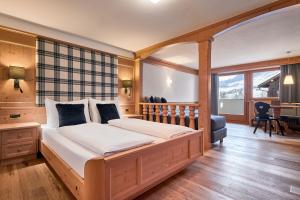 Un ou plusieurs lits dans un hébergement de l'établissement Hotel Des Alpes