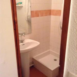 a bathroom with a sink and a toilet and a mirror at Les studios du chalet club Valfréjus in Modane